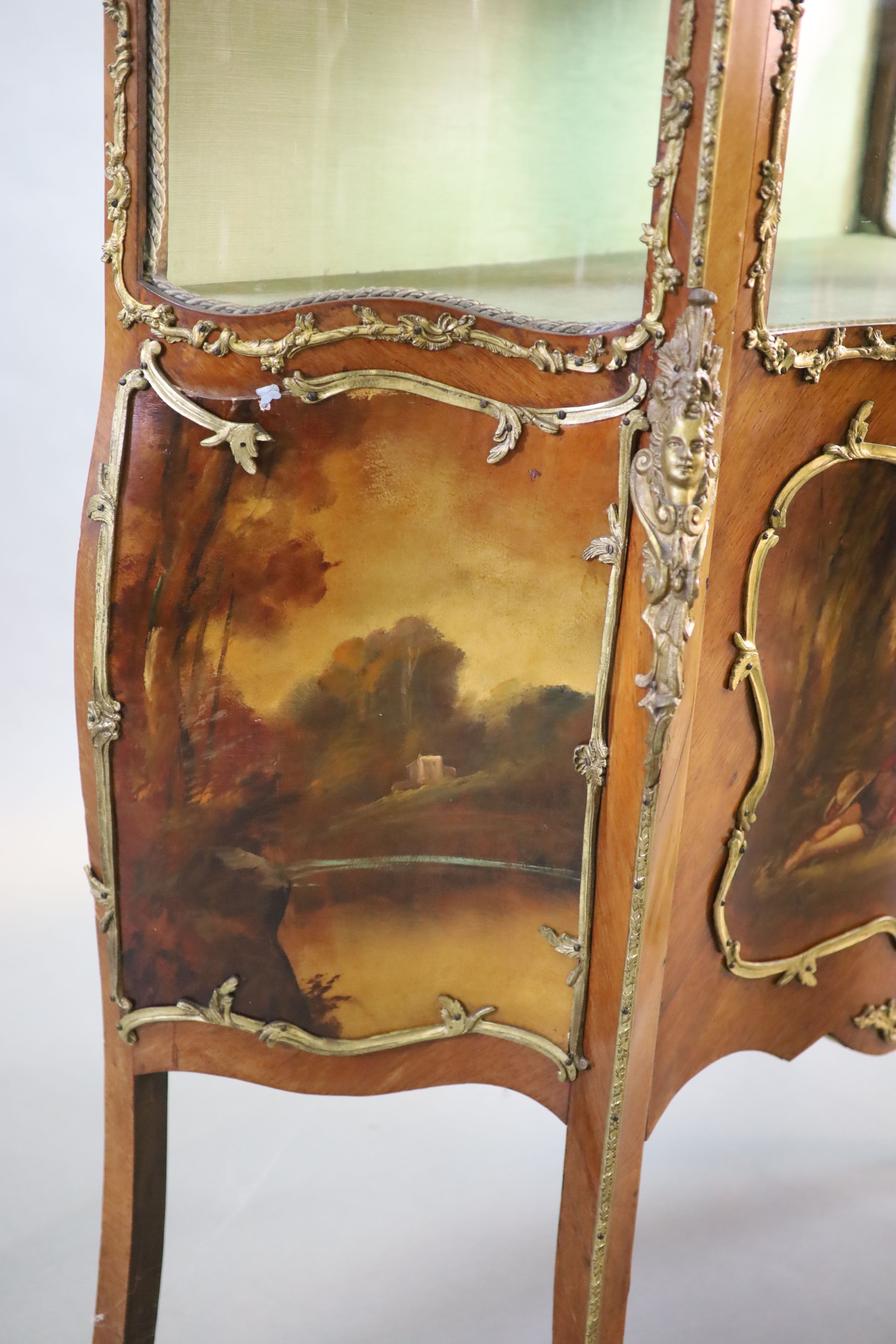 A Louis XV style mahogany vitrine, 76cm wide, 38cm deep, 194cm high.